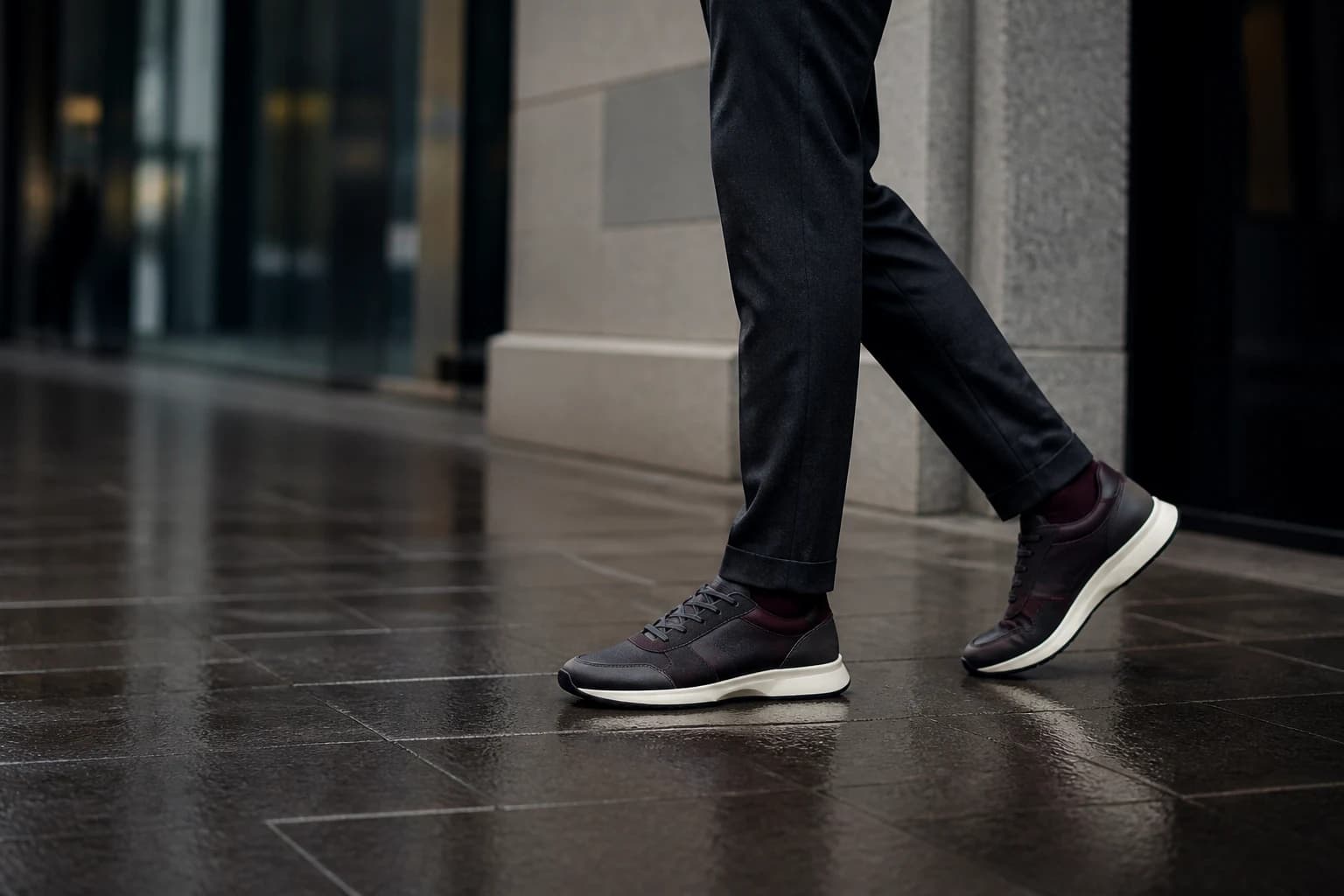 Premium burgundy footwear worn on a modern city street